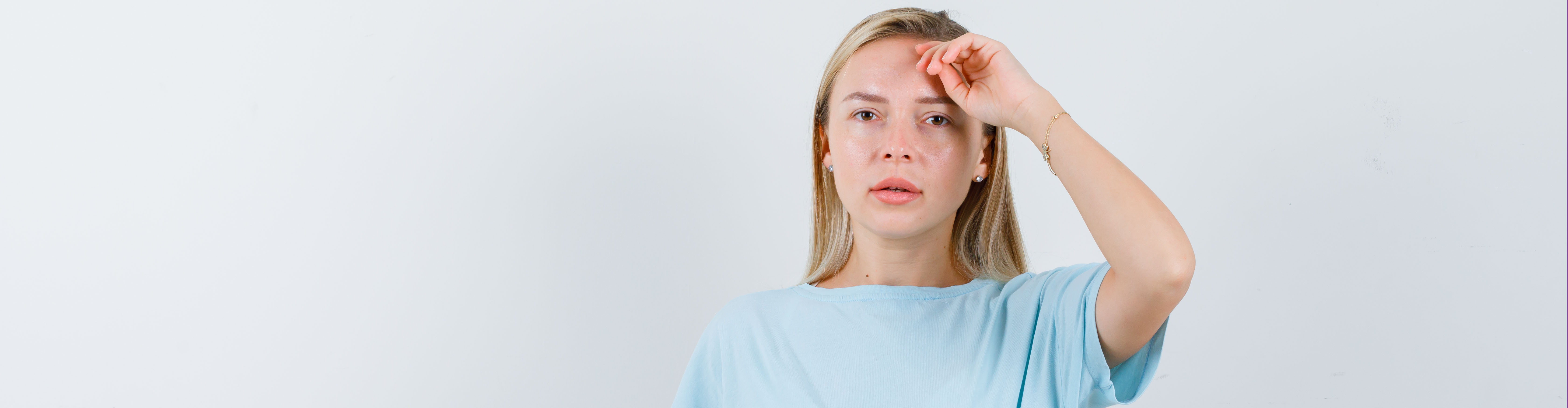Blonde Woman Blue T Shirt Holding Hand Head Looking Serious Header Content